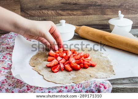 cooking processes rye and bran biscuit with fresh strawberries, vegan dessert, clean eating