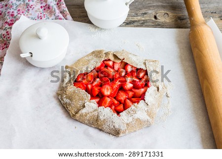 cooking processes biscuit with fresh strawberries, healthy dessert, raw pie, vegan
