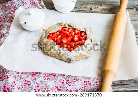 cooking processes biscuit with fresh strawberries, healthy dessert, raw pie, vegan, selective focus