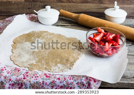 cooking processes rye biscuit with fresh strawberries, healthy dessert, vegan food