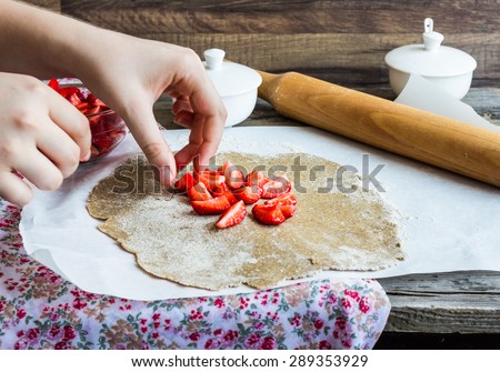 cooking processes rye biscuit with fresh strawberries, healthy vegan dessert, hands