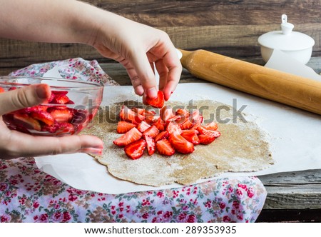 cooking processes biscuit with fresh strawberries, vegan dessert, clean eating,raw pie