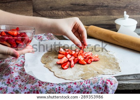 cooking processes rye biscuit with fresh strawberries, healthy vegan dessert, hands,pie