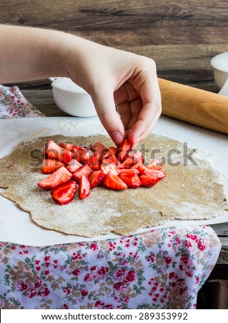 cooking processes rye biscuit with fresh strawberries, healthy vegan dessert, hands, selective focus