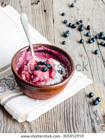 banana ice cream with blueberries and coconut flakes, healthy dessert, vegan breakfast, selective focus