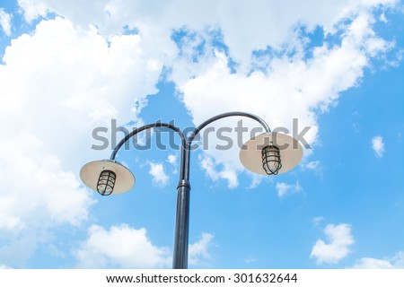 Electric Street lamp against blue sky