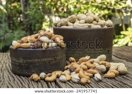 Pigeon peas mixed nuts such as pistachios, peanuts, cashews and almond on a wooden table.