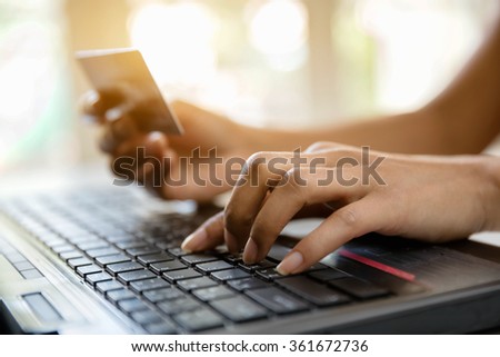 Hands holding credit card and-using laptop online shopping