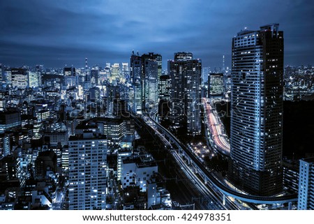 Dense buildings in Minato-ku, Tokyo Japan with Tokyo Sky tree visible on the horizon.