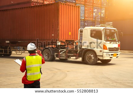 Foreman control loading Containers box to truck for Logistic Import Export Background, Business logistic concept