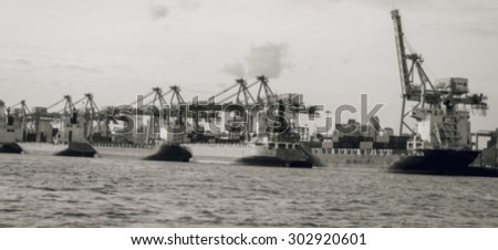 container ship entering port with sunset time,Image blur is tone black and white