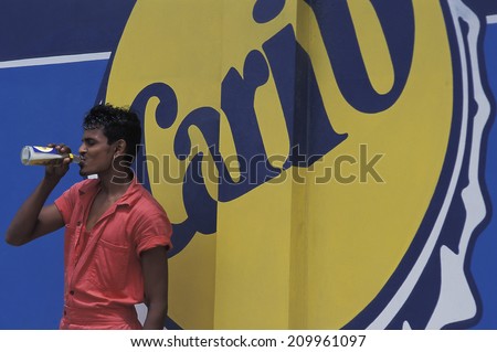 PORT OF SPAIN, TRINIDAD AND TOBAGO - AUGUST 7, 2011. Carib is the popular beer brewed in Trinidad, and Carib signs are a common sight. People of East Indian ancestry represent half of the population.