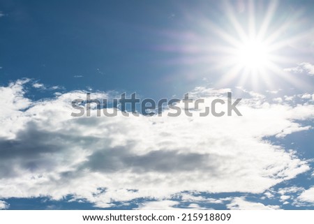 star of sun in blue sky and white clouds with space on left corner
