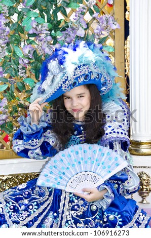 Little Princess (smiling little girl wearing an antique princess dress and holding a blue fan)