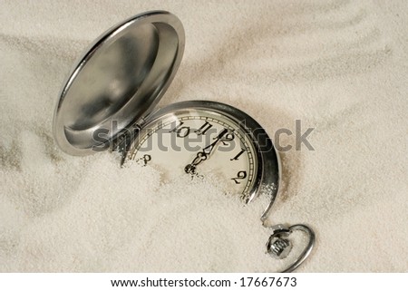 Antique watch covered with sand