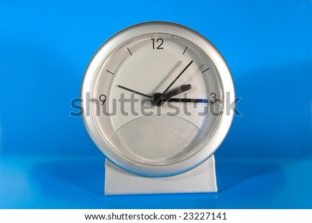 Simple gray desk clock (on a bright blue background)