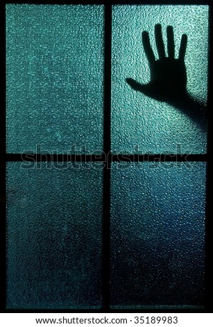 Silhouette of a hand behind a window or glass door (symbolizing horror or fear)
