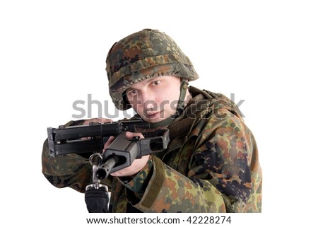 stock photo : Portrait of a soldier aiming a gun (with focus on the soldierâ