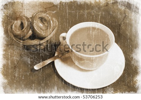 White coffee cup with freshly made coffee and a small woven basket full of bagels (vintage style)
