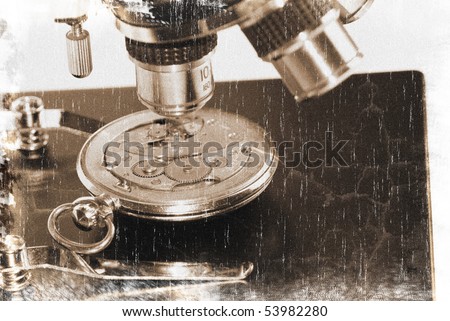 Old watch mechanism under microscope objectives (vintage style)