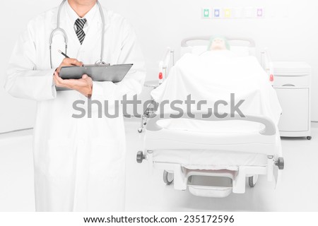 Doctor writing on a folder of diagnosis result in patient room