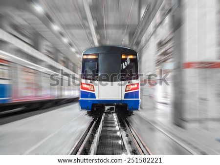 Moving train in maintenance workshop with motion blur