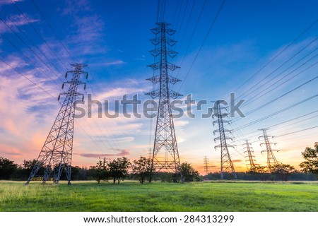 High voltage electricity pylon on sunrise background