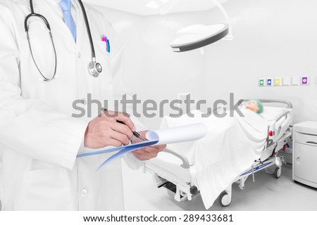 Doctor writing a medical prescription in delivery room