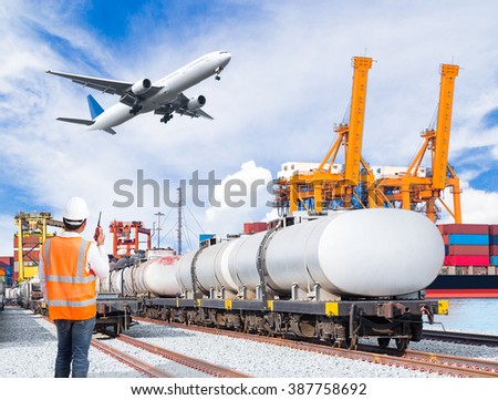 Dock worker talking with radio communication against freight train for fuel transport and cargo plane in front of the harbor, logistic import export concept
