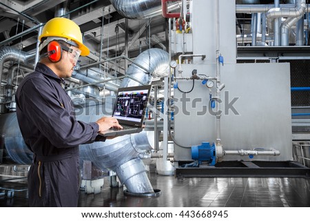 Engineer using laptop computer in thermal power plant factory