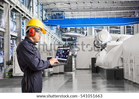 Engineer using laptop computer for maintenance equipment in thermal power plant factory