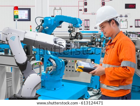 Maintenance engineer programing automated robotic at industry 4.0 concept