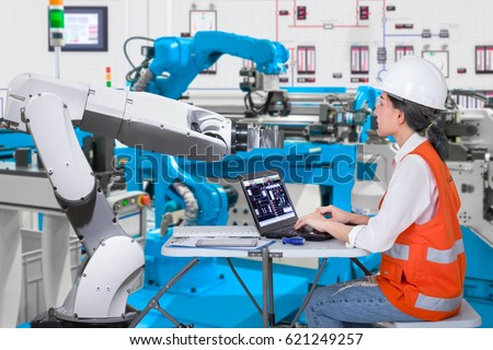 Woman software engineers developing automated robotic in production line, Industry 4.0 concept