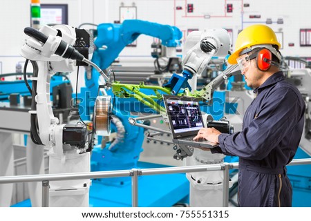 Engineer using laptop computer maintenance automatic robotic industry, Industry 4.0 concept