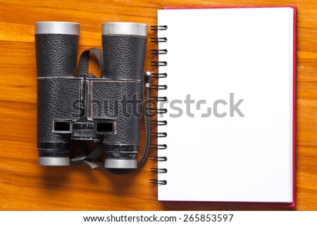 vintage binoculars and notebook