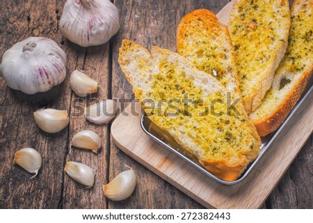 Garlic bread on old wood background