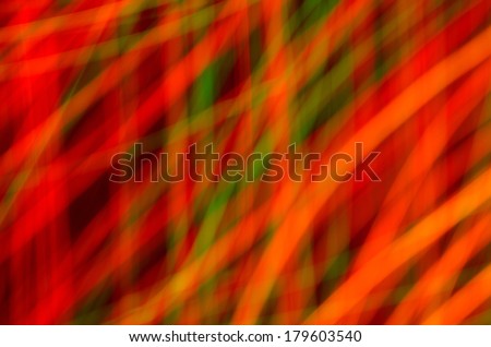 Abstract colorful strands of soft blurred streaming lights in motion on black background