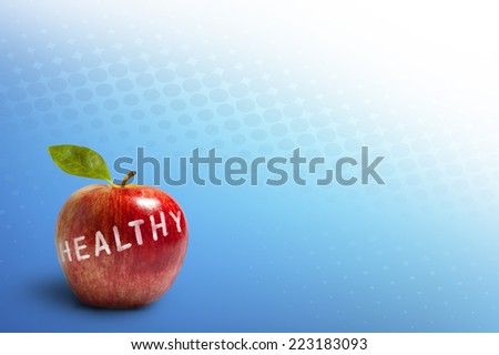 Healthy red apple with leaf and word healthy isolated on abstract blue dot pattern background.