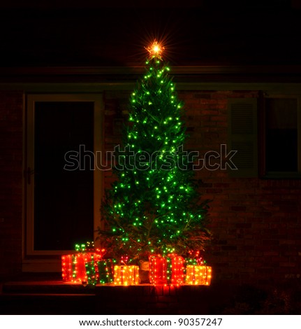 Green Lights On Christmas Tree With Gifts Made Of Lights And Gold Star 
