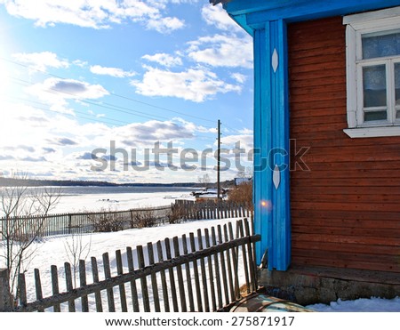 Wooden house in the village in winter sunny day