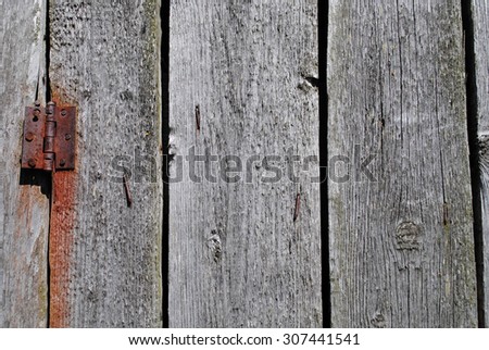 Old wooden door with rusty door hinge