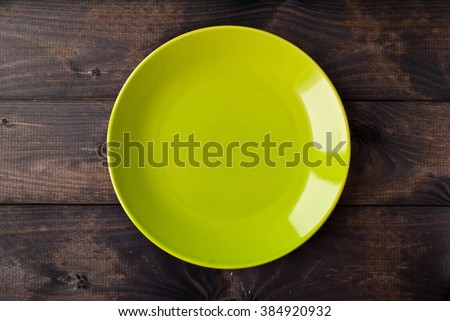 Empty plate on rustic wooden background. Top view