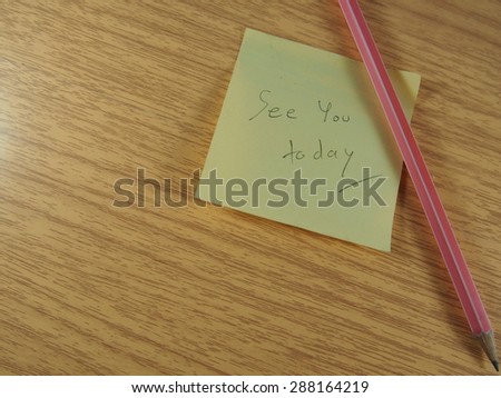 See you today phrase with pink pencil on wood background