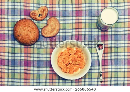 Breakfast corn flakes with cookies and milk