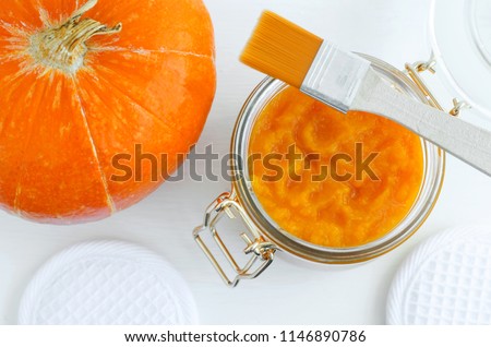 Homemade pumpkin face mask in a glass jar. DIY cosmetics and spa. Top view, Copy space.
