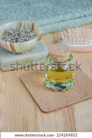 Small bottle of cosmetic oil, dried herbs and organic soap