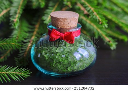 Small bottle of bath salt and christmas tree branches