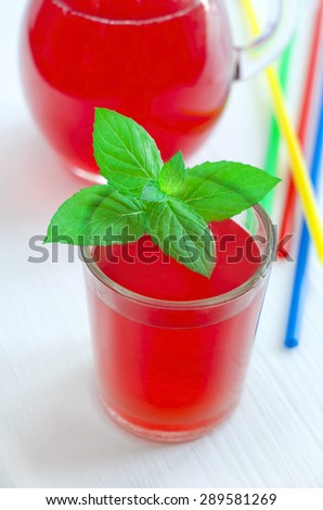 A glass of red juice (cocktail) with mint leaves