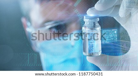 A futuristic doctor with syringe picks up the DNA from a test tube and appears a hologram of a patient\'s DNA. Concept: Futuristic medicine, medical care, future, dna, kinship, family