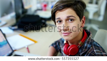 Young boy student, studying computer and is happy to learn new things